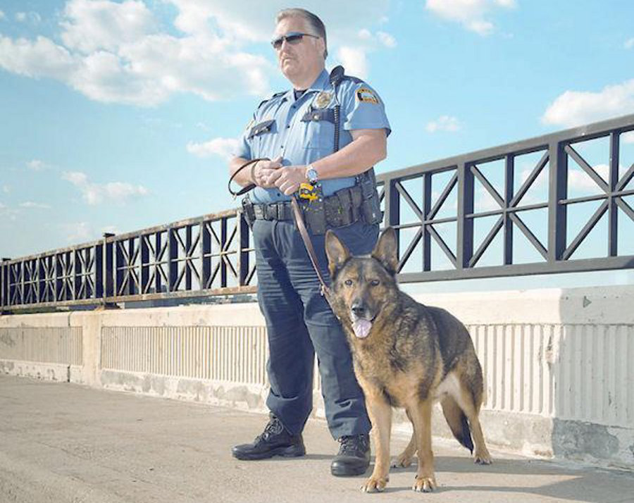 St. Paul Police Officer Dave Longbehn and K-9 Kody are seen on St. Paul's High Bridge in the summer of 2012.
