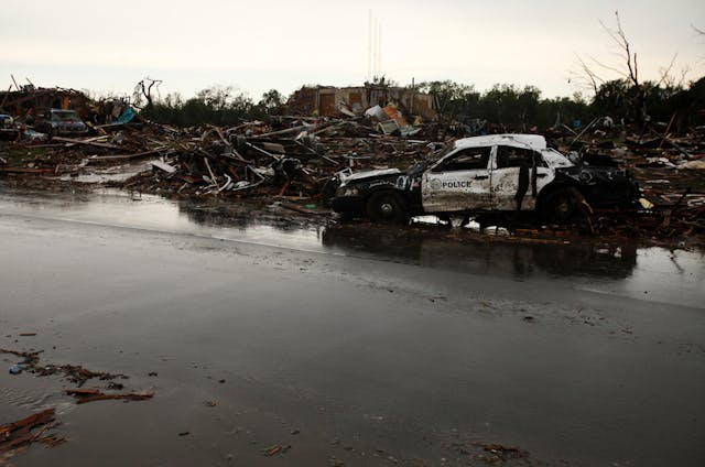 A Del City police car sits damaged along Kings Manor in Moore, Okla on May 21.