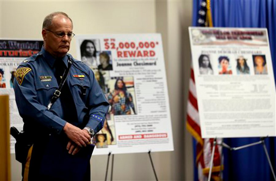 Col. Rick Fuentes, superintendent of the New Jersey State Police, stands next to posters during a news conference giving updates on the search of Joanne Chesimard on May 2, 2013.