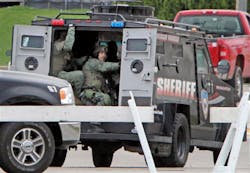 The Dane County Sheriff's Office Tactical Response Team drives away from a makeshift command center at Fire Station 2 in Fitchburg, Wis. on May 2. The Dane County Sheriff's Office Tactical Response Team drives away from a makeshift command center at Fire Station 2 in Fitchburg, Wis. on May 2.