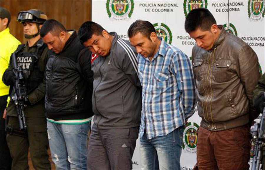 Police present to the press four alleged gang members who were arrested in connection with the murder of U.S. DEA Special Agent James &apos;Terry&apos; Watson at police headquarters in Bogota, Colombia on June 26.