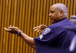 Detroit Sgt. Anthony Potts shows the way to use two hands in holding the MP-5, which is the weapon Officer Joseph Weekley used in the raid of the home where Aiyana Stanley-Jones was killed.