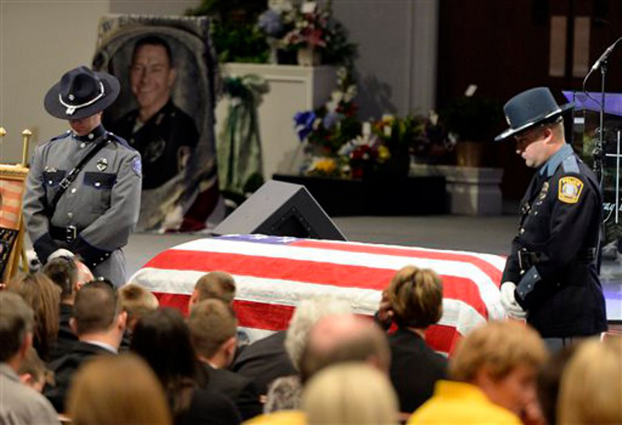 Members of the University of Kentucky and Lexington, Ky. Police Departments stand in honor to Officer Jason Ellis during his funeral service on May 30 in Bardstown, Ky.