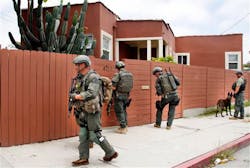 Los Angeles Sheriff's deputies search a city street for suspects after two police officers were shot and wounded in an attack outside a police station in the Mid-City area of Los Angeles on June 25. Los Angeles Sheriff's deputies search a city street for suspects after two police officers were shot and wounded in an attack outside a police station in the Mid-City area of Los Angeles on June 25.