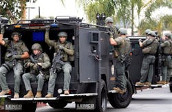 Los Angeles Sheriff's deputies search a city street for suspects after two police officers were shot and wounded in an attack outside a police station in the Mid-City area on June 25. Los Angeles Sheriff's deputies search a city street for suspects after two police officers were shot and wounded in an attack outside a police station in the Mid-City area on June 25.