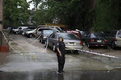 An NYPD police officer holds crime scene tape near a crime scene where three people were shot over the weekend in Brooklyn on June 3. An NYPD police officer holds crime scene tape near a crime scene where three people were shot over the weekend in Brooklyn on June 3.