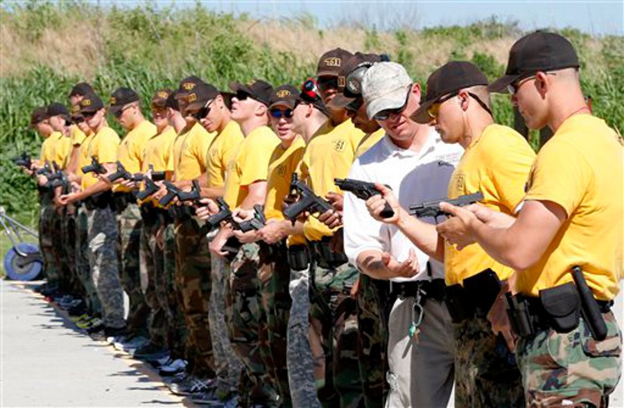 Oklahoma State Trooper Shane Hackler, third from right, instructs cadets on a pistol firing range Oklahoma City on June 11.