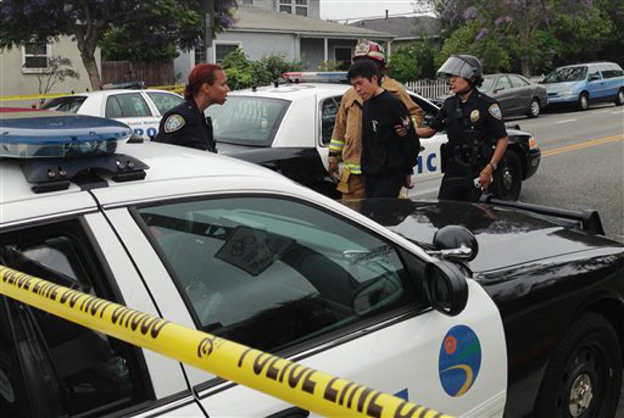 Los Angeles police officers are shown detaining a man near a shooting at Santa Monica College on June 7.