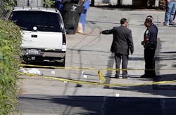 Police investigate the scene of a daylight shooting that left two men wounded in Santa Monica, Calif. on June 11.