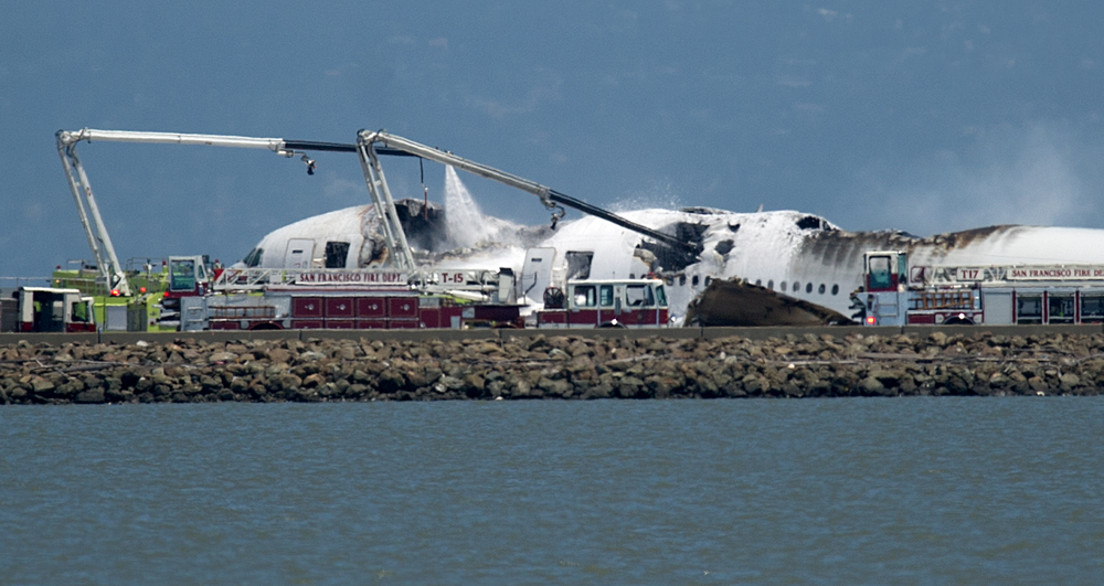 A fire truck sprays water on Asiana Flight 214 after it crashed at San Francisco International Airport on July 6.
