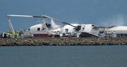 A fire truck sprays water on Asiana Flight 214 after it crashed at San Francisco International Airport on July 6.