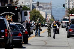 San Francisco Police officers and FBI officials work the scene near at Eighth Street and Brannan Street after a shooting in San Francisco on July 12.