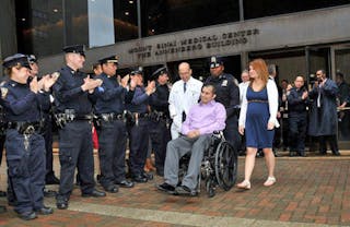 NYPD Officer Eder Loor leaves the hospital with his wife, Dina, by his side on May 2, 2012. Dina joined the police department this week after graduating from the academy.