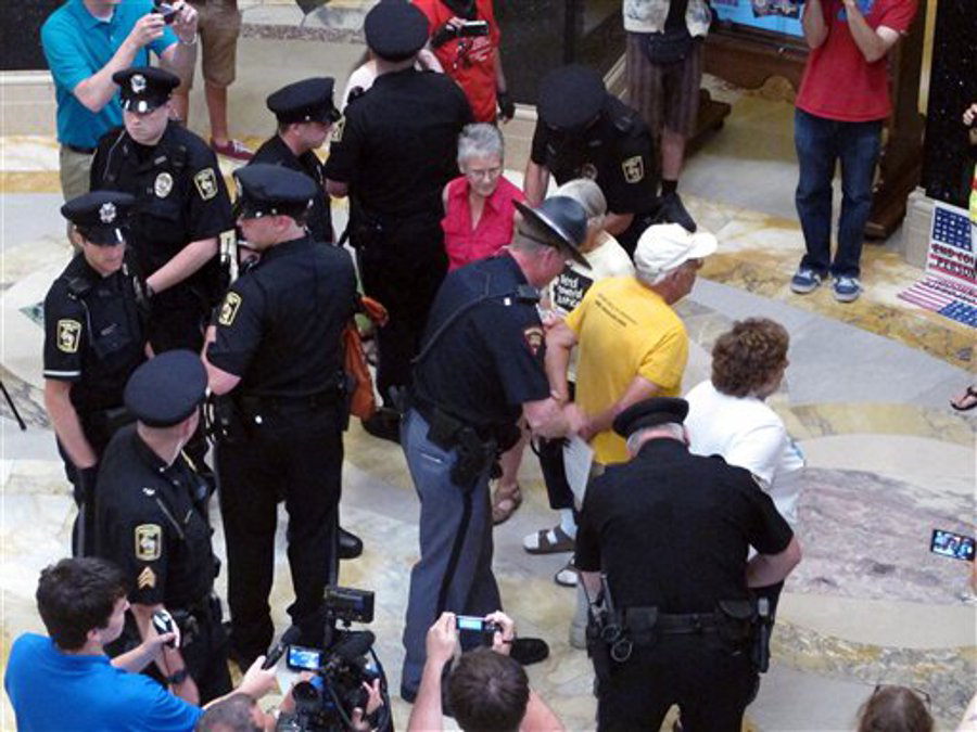 Wisconsin Capital Police arrest people gathered in the state Capitol rotunda for the daily noontime singalong on July 24 in Madison, Wis.