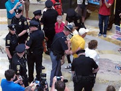 Wisconsin Capital Police arrest people gathered in the state Capitol rotunda for the daily noontime singalong on July 24 in Madison, Wis. Wisconsin Capital Police arrest people gathered in the state Capitol rotunda for the daily noontime singalong on July 24 in Madison, Wis.