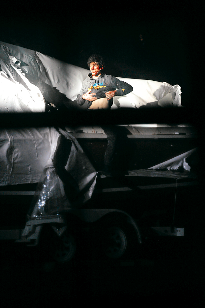 Boston Marathon bombing suspect Dzhokhar Tsarnaev lifts his shirt while standing in a boat at the time of his capture by law enforcement authorities in Watertown, Mass. on April 19.