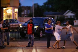 Latayna Herring is held back after she broke down screaming at police near the scene where her 21-year-old son was shot and killed on Aug. 10 in Chicago. Latayna Herring is held back after she broke down screaming at police near the scene where her 21-year-old son was shot and killed on Aug. 10 in Chicago.