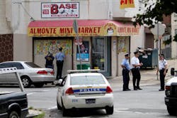 Investigators gather outside a corner store on N. 4th Street in the Feltonville section of Philadelphia on Aug. 13 after a police officer was shot. Investigators gather outside a corner store on N. 4th Street in the Feltonville section of Philadelphia on Aug. 13 after a police officer was shot.