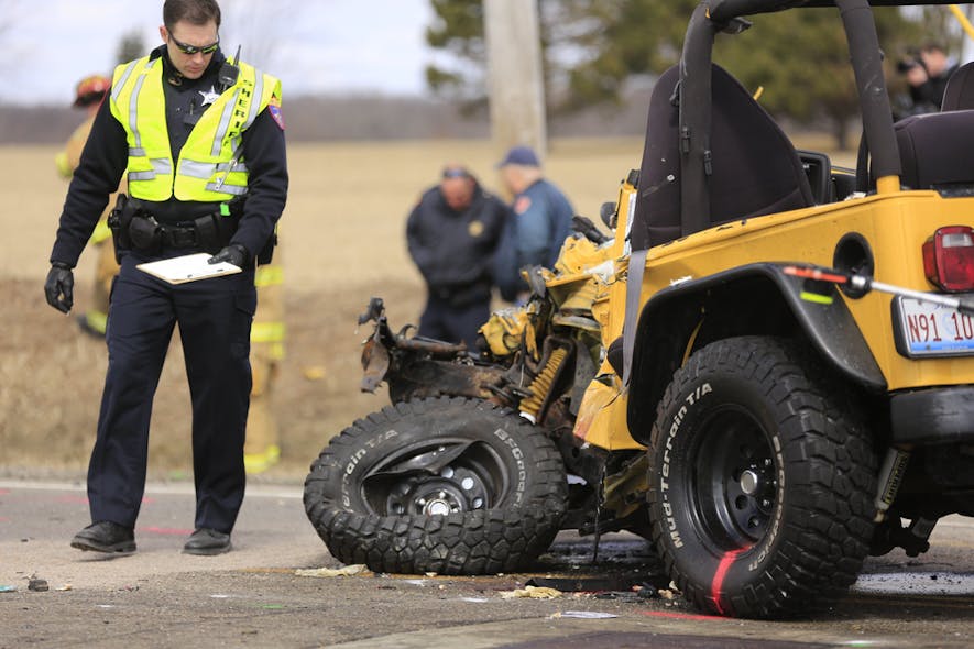 A Lake County Sheriff&apos;s Police investigator examines a vehicle involved on April 5 in an accident with a school bus near Zion, Ill.