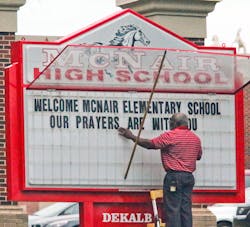 A McNair High school staff member works on a welcome sign for Ronald E. McNair Discovery Learning Academy students on Aug. 21.