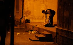 A Chicago police officer picks through debris at the crime scene where a number of people were shot, including a 3-year-old child, in a city park on Sept. 19. A Chicago police officer picks through debris at the crime scene where a number of people were shot, including a 3-year-old child, in a city park on Sept. 19.