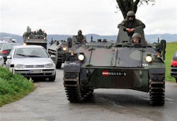 Austrian army soldiers in an armored vehicle arrive near the villages of Grosspriel and Kollapriel on Sept. 17 where a man was barricading himself inside a farm building after he killed three police officers and the driver of an emergency rescue vehicle.