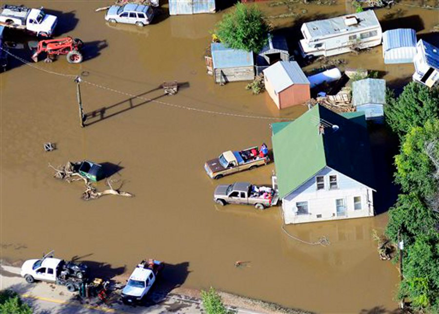 Victims of last week's devastating floods retrieve belongings outside a home near the East Platte River east of Greeley, Colo. on Sept. 17.