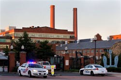 Police cars line the gate in the early morning as essential personnel only are allowed into a closed Washington Navy Yard in Washington on Sept. 17. Police cars line the gate in the early morning as essential personnel only are allowed into a closed Washington Navy Yard in Washington on Sept. 17.