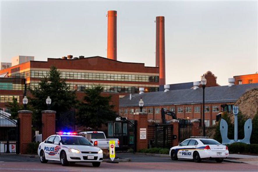 Police cars line the gate in the early morning as essential personnel only are allowed into a closed Washington Navy Yard in Washington on Sept. 17.