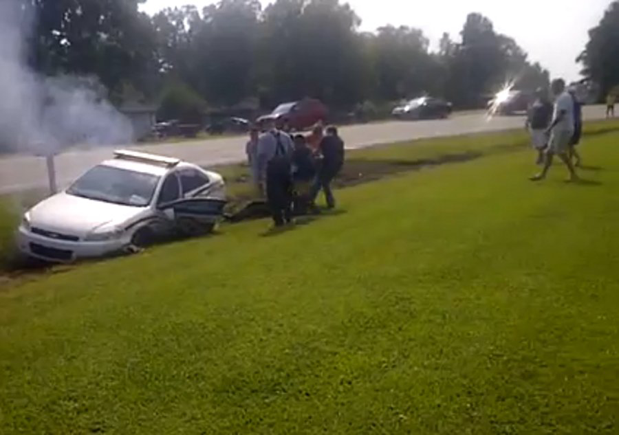 A group of bystanders pulled a Wilson's Mills, N.C. police officer from his cruiser on Sept. 1 after the vehicle wound up in a ditch before catching fire.