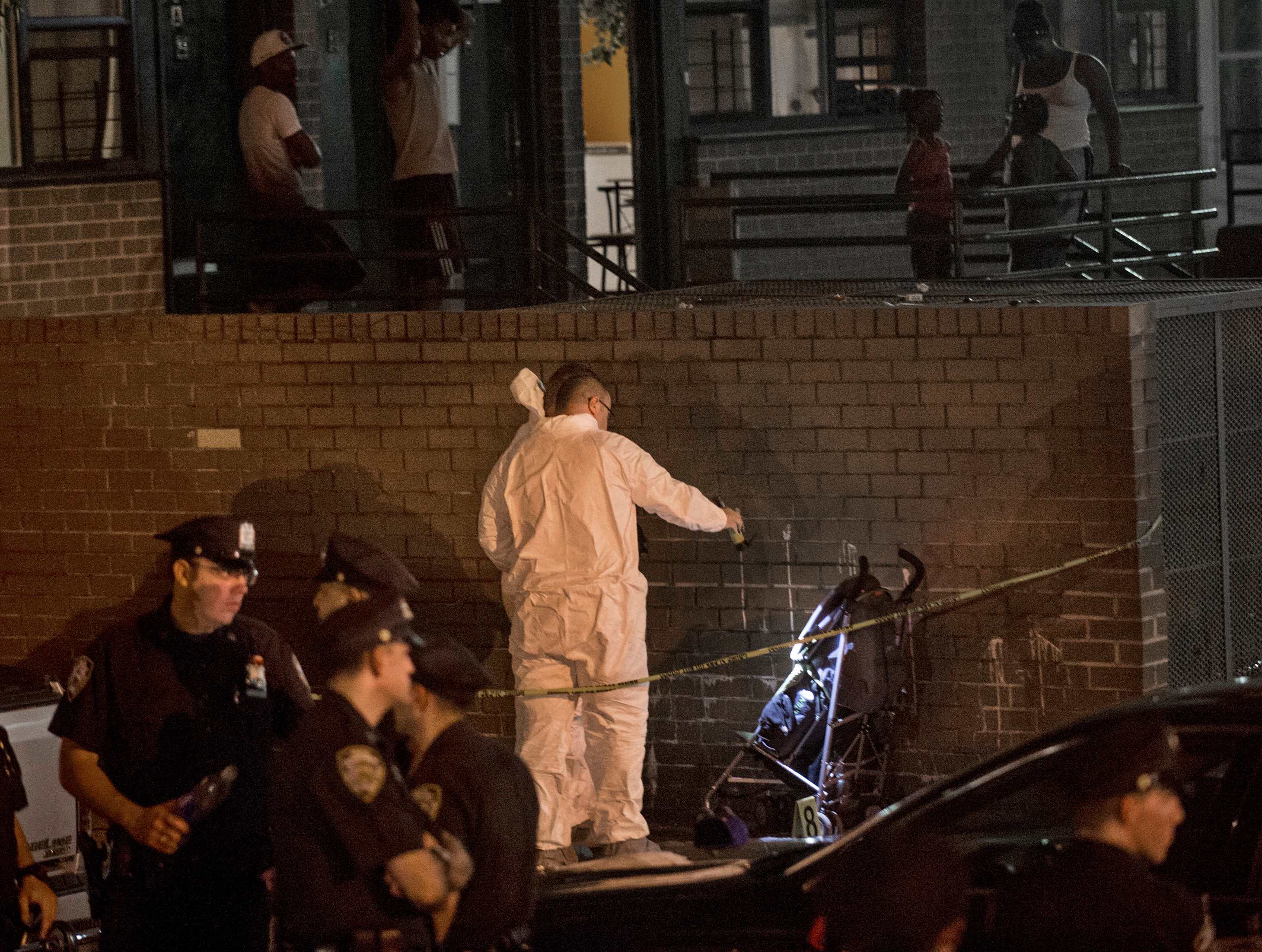 Police investigate the scene where a 1-year-old was fatally shot on Sept. 1 in the Brownsville neighborhood of the Brooklyn borough of New York.