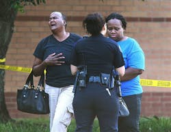 A pair of women react after at least one person was killed and others injured in an altercation inside Spring High School on Sept. 4 in Spring, Texas.