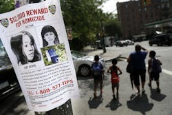A poster soliciting information regarding an unidentified body near the site where the body was found is seen in New York.