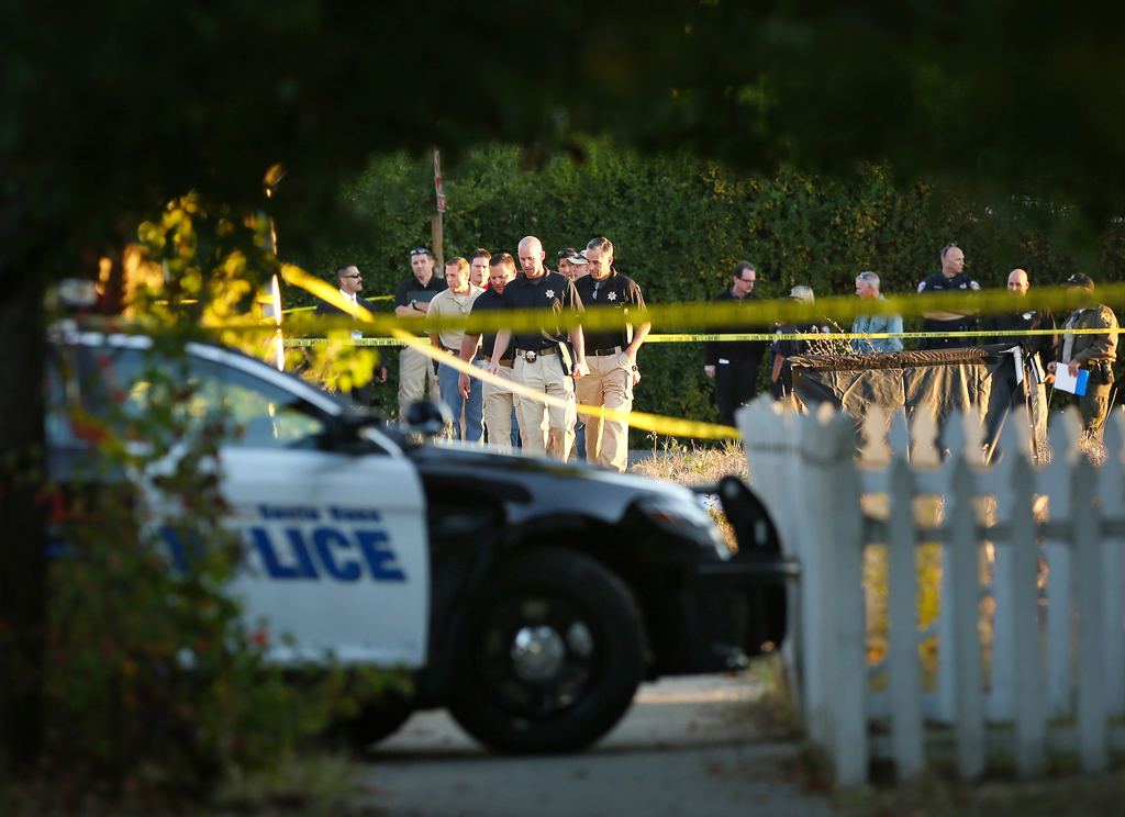 Law enforcement investigators look over the body of a 13-year-old boy shot and killed by officers in Santa Rosa, Calif. on Oct. 22.