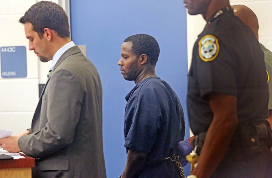 Convicted murderer Charles Walker, center, with a public defender, at left, faces a Circuit Judge on Oct. 23 at the Orange County jail after escaping from a North Florida prison using forged