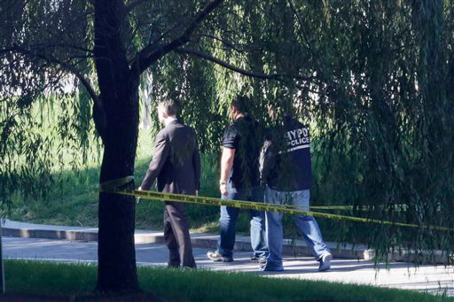 Crime scene investigators walk along a path in New York's Riverside Park South where a man earlier went on a rampage stabbing five people, including a toddler on Oct. 1.