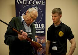 : Legendary custom gunmaker Jerry Fisher examines a student's work at GCCF 2013. : Legendary custom gunmaker Jerry Fisher examines a student's work at GCCF 2013.