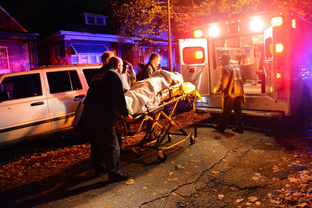 An unidentified person is moved to an ambulance after four people were shot, resulting in one fatality in Chicago's South Side on Nov. 6.