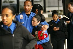 Transportation Security Administration officers hug as they meet in front of LAX terminal three on Nov. 4 just days after a deadly shooting there in Los Angeles.