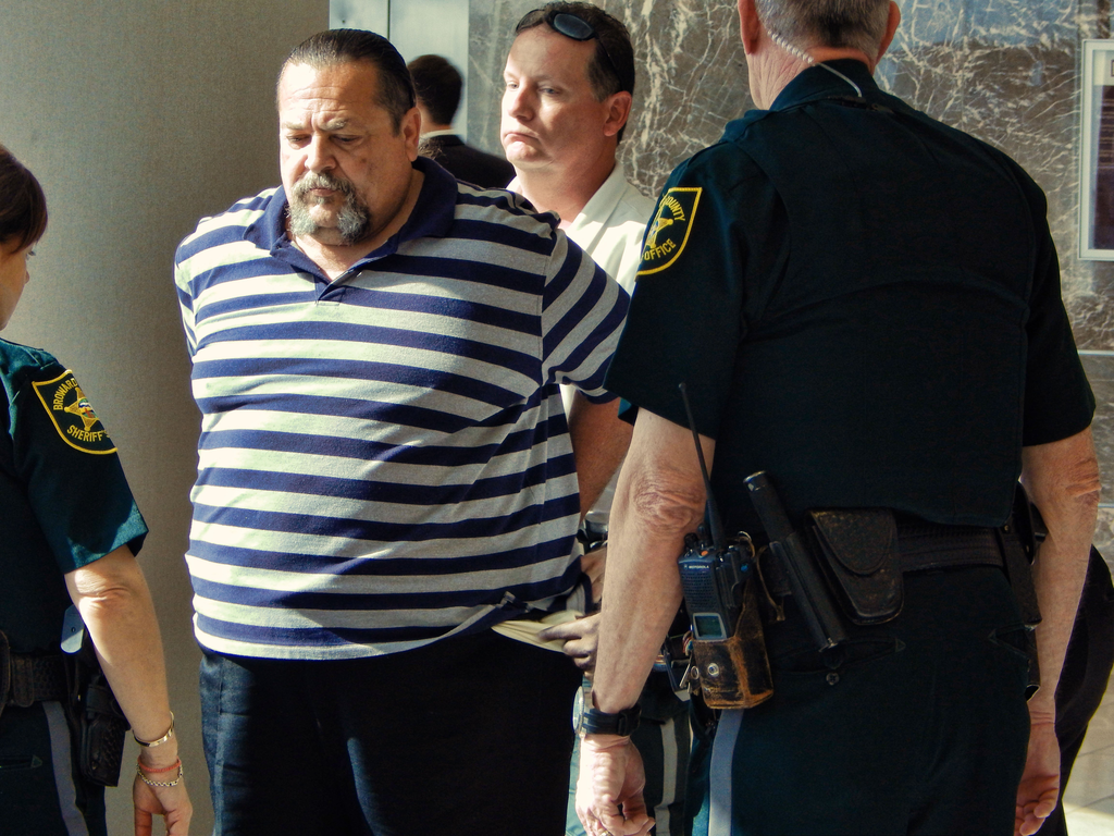 Juan Gonzalez, 56, is taken into custody at the Broward Courthouse in Florida, after being accused of attacking John Powers, 54, in the bathroom of the Broward courthouse on Dec. 10.