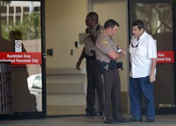 Miam-Dade commissioner Jose 'Pepe' Diaz, right, talks to police officers at the Ryder Trauma Center at Jackson Memorial Hospital after an armed drugstore robbery and subsequent manhunt that left three officers shot, and two suspects dead, in Northwest Miami-Dade on Dec. 10. Miam-Dade commissioner Jose 'Pepe' Diaz, right, talks to police officers at the Ryder Trauma Center at Jackson Memorial Hospital after an armed drugstore robbery and subsequent manhunt that left three officers shot, and two suspects dead, in Northwest Miami-Dade on Dec. 10.