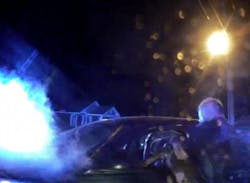 Wilmington Police Officer Stafford Brister can be seen lifting his dog into the car window of a suspect. Wilmington Police Officer Stafford Brister can be seen lifting his dog into the car window of a suspect.