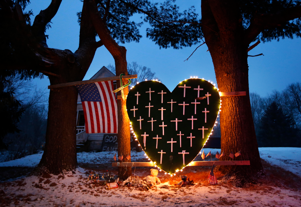 A makeshift memorial with crosses for the victims of the Sandy Hook massacre stands outside a home in Newtown, Conn. on the one-year anniversary of the shootings.