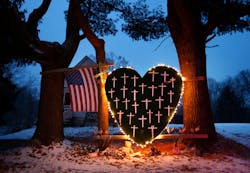 A makeshift memorial with crosses for the victims of the Sandy Hook massacre stands outside a home in Newtown, Conn. on the one-year anniversary of the shootings.