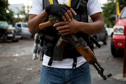 An armed man belonging to the Self-Defense Council of Michoacan stands guard at a checkpoint set up by the self-defense group at the entrance to Antunez, Mexico.