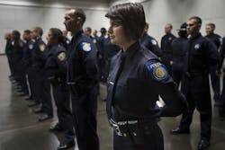 Emily Kane prepares for the Sacramento Police Department graduation ceremony at the Convention Center in Sacramento, Calif., on Dec. 19.