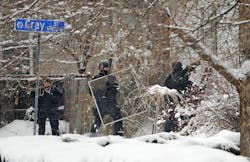 Police rush into a home during a hostage situation on Feb. 4 in Arvada, Colo. Police rush into a home during a hostage situation on Feb. 4 in Arvada, Colo.