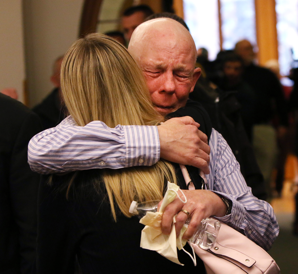 Paul Butterfield, the father of slain Michigan State Police Trooper Paul Butterfield II, embraces his son's fiance Jennifer Sielski after guilty verdicts were read against Eric Knysz on Feb. 25.