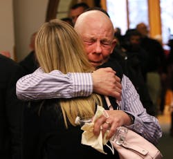 Paul Butterfield, the father of slain Michigan State Police Trooper Paul Butterfield II, embraces his son&apos;s fiance Jennifer Sielski after guilty verdicts were read against Eric Knysz on Feb. 25.