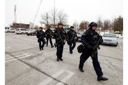 Police move in from a parking lot to the Mall in Columbia after reports of a multiple shooting in Columbia, Md. on Jan. 25.